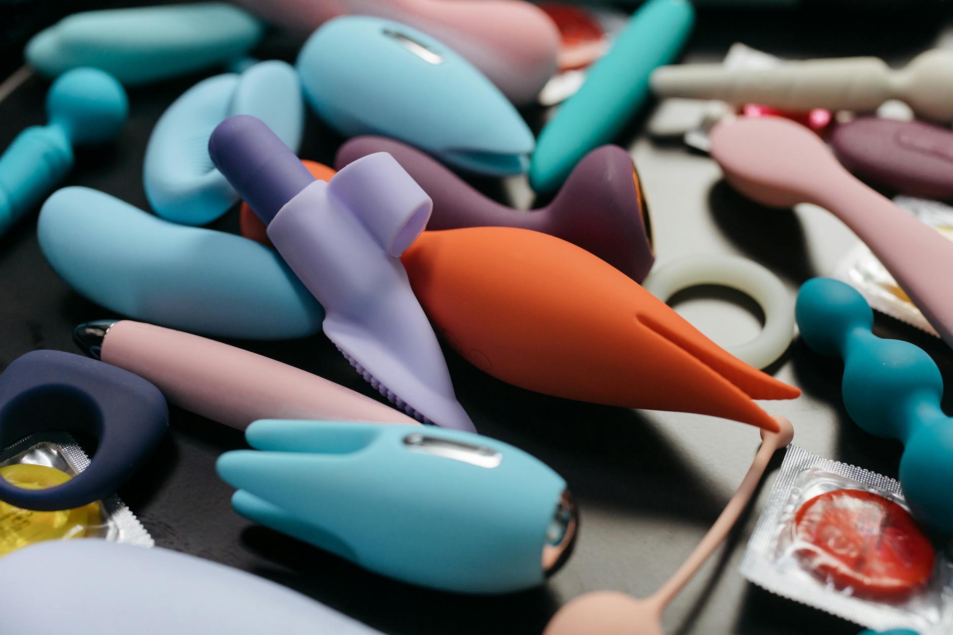 Woman holding a vibrator with books in the background, representing intimacy and personal agency